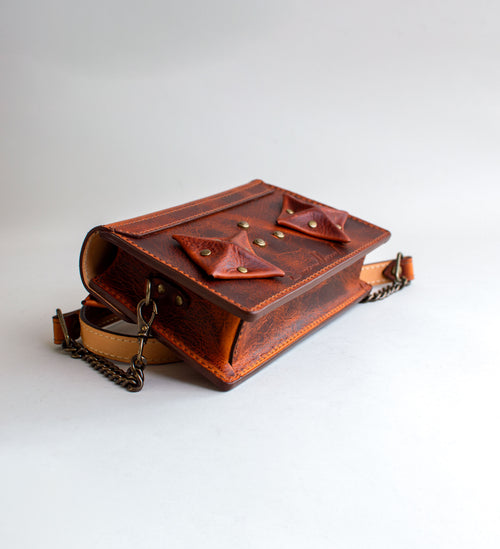 Rear-View-Of-Amber-Colored-luxury-leather-handbag-with-folded-origami-leather-embellishments-handmade-in-the-us-with-brass-hardware