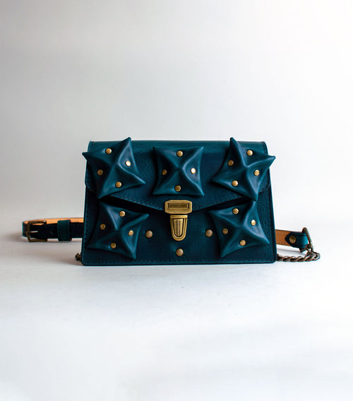 front-View-Of-Aquatic-green-Colored-Waxy-luxury-leather-handbag-handmade-in-the-us-with-brass-hardware-and-folded-origami-leather