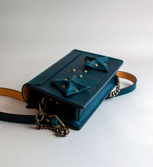 Rear-View-Of-Aquatic-green-Colored-Waxy-luxury-leather-handbag-handmade-in-the-us-with-brass-hardware-and-folded-origami-leather