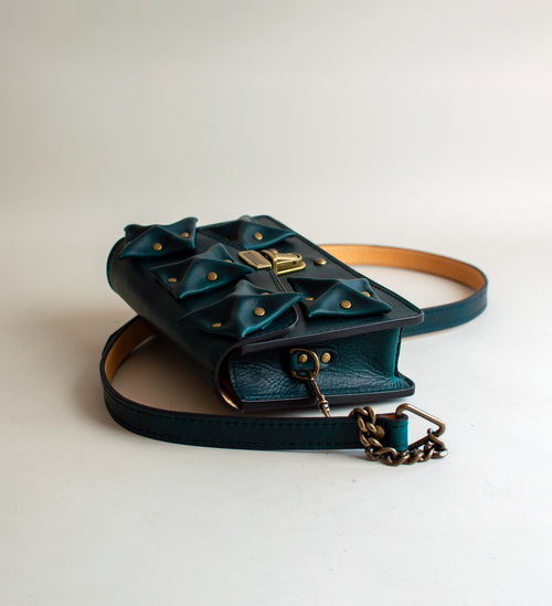 side-view-of-aquatic-green--luxury-waxy-leather-handbag-with-brass-hardware-handmade-in-the-US