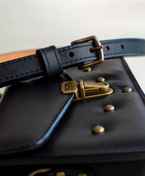 close-up-view-of-black--luxury-waxy-leather-handbag-with-brass-hardware-handmade-in-the-US