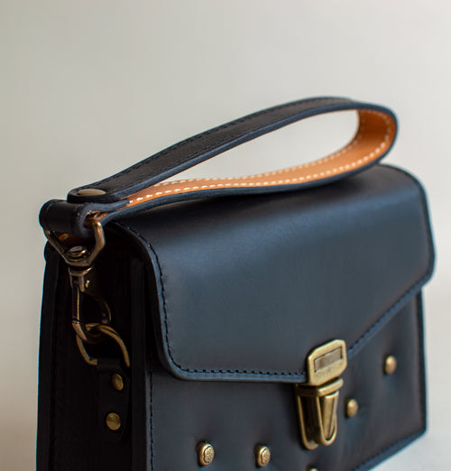 Strap-view-of-black--luxury-waxy-leather-handbag-with-brass-hardware-handmade-in-the-US