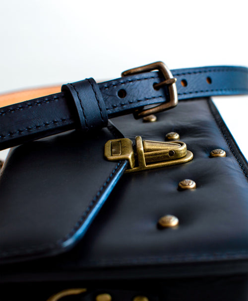 Close-up-View-Of-Black-Colored-luxury-leather-handbag-handmade-in-the-us-with-brass-hardware-and-padding