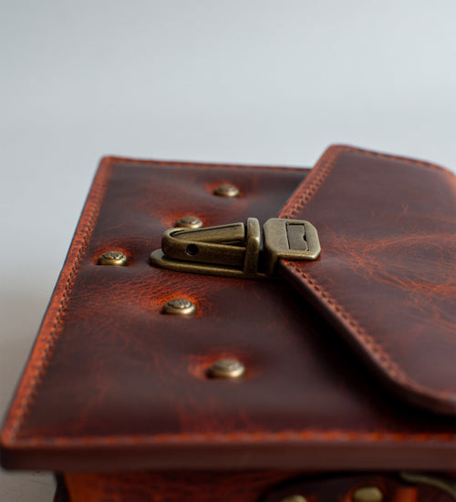 close-up-View-Of-Amber-Colored-Waxy-luxury-leather-handbag-handmade-in-the-us-with-brass-hardware