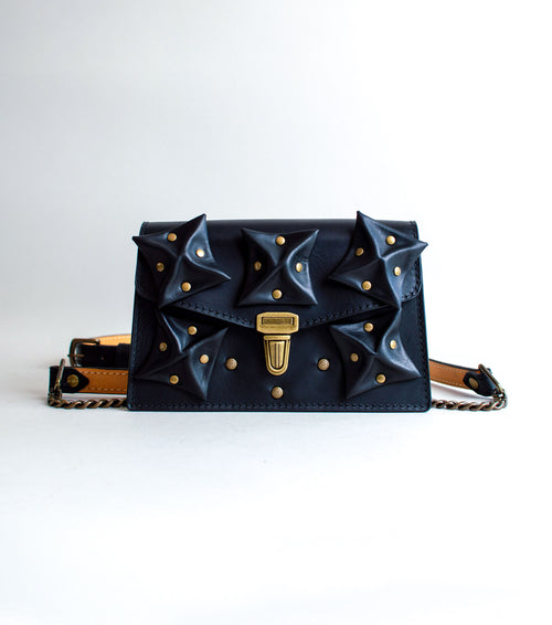 front-View-Of-Black-Colored-luxury-leather-handbag-with-folded-origami-leather-embellishments-handmade-in-the-us-with-brass-hardware