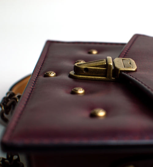 Close-up-View-of-small-padded-handmade-luxury-purse-made-out-of-dark-red-italian-leather-by-duncan-maxwell