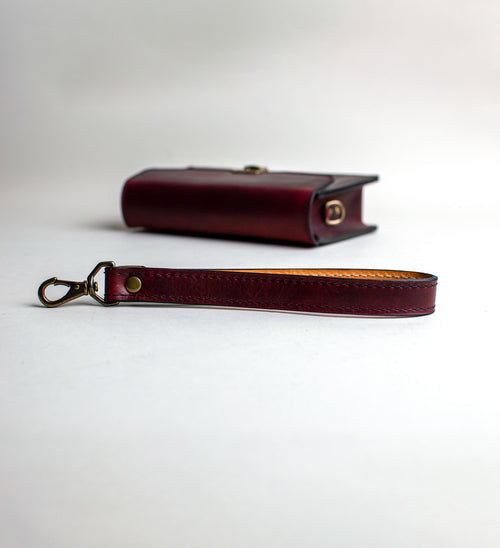 Strap-View-of-small-padded-handmade-luxury-purse-made-out-of-dark-red-italian-leather-by-duncan-maxwell