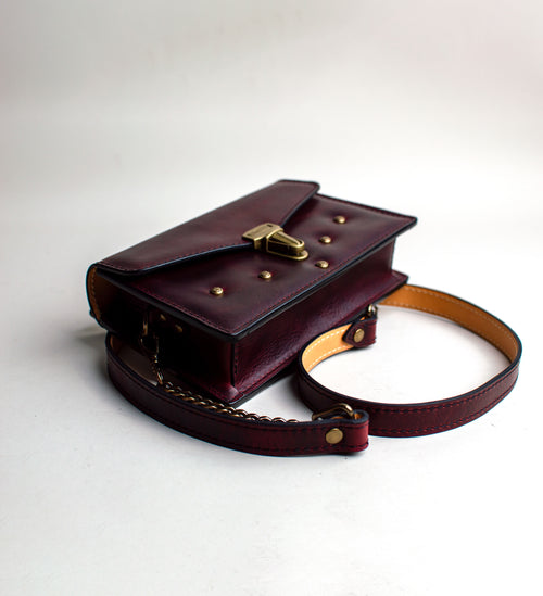 side-View-of-small-padded-handmade-luxury-purse-made-out-of-dark-red-italian-leather-by-duncan-maxwell