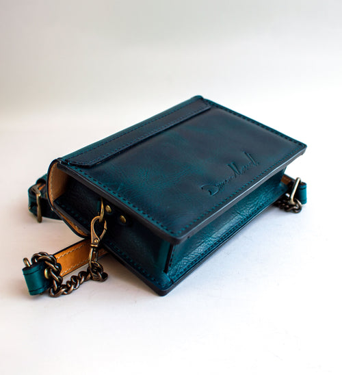 rear-view-of-handmade-luxury-leather-purse-with-padding-and-folded-leather-bow-featuring-antique-brass-hardware-by-Duncan-Maxwell