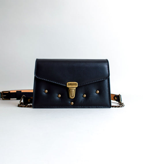 front-View-Of-Black-Colored-luxury-leather-handbag-handmade-in-the-us-with-brass-hardware-and-padding